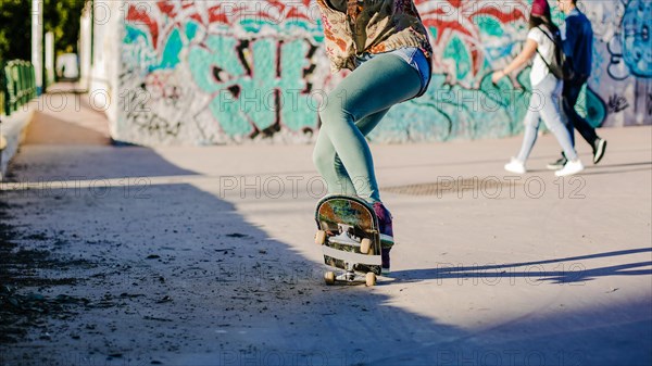 Girl riding skateboard making stunts