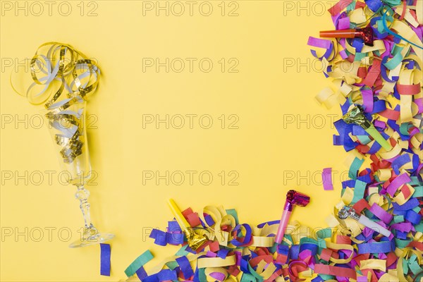 Glass party horns near confetti