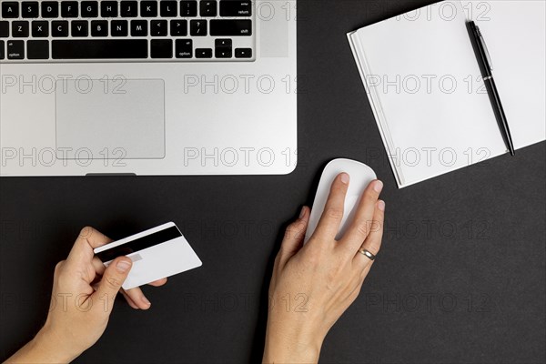 Hand using mouse holding credit card