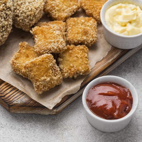 High angle fried chicken nuggets with two different sauces