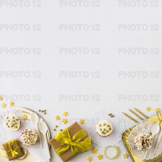 High angle view muffins gifts edge white backdrop