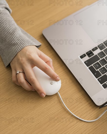 High angle woman laptop using mouse