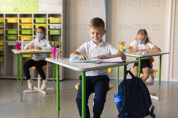 Kids keeping social distance classroom