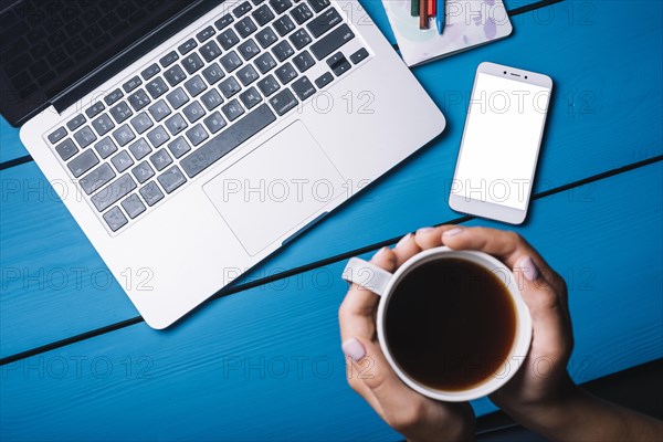 Laptop smartphone blue desk with coffee