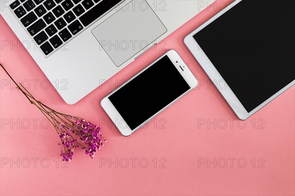 Laptop with tablet smartphone pink table
