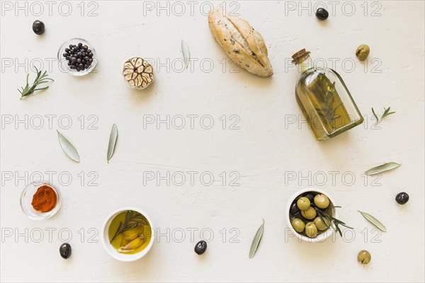 Layout oil bottle bread olives spices
