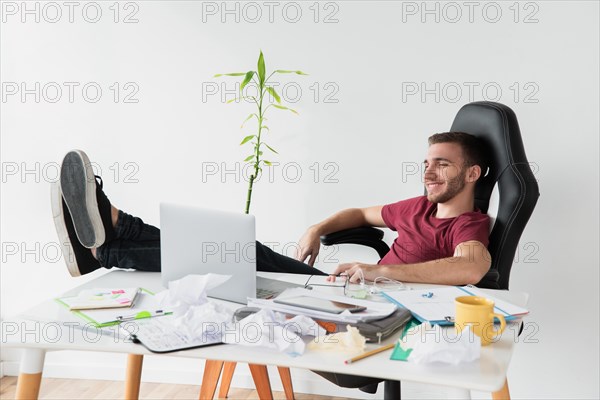 Man relaxing himself sitting gaming chair