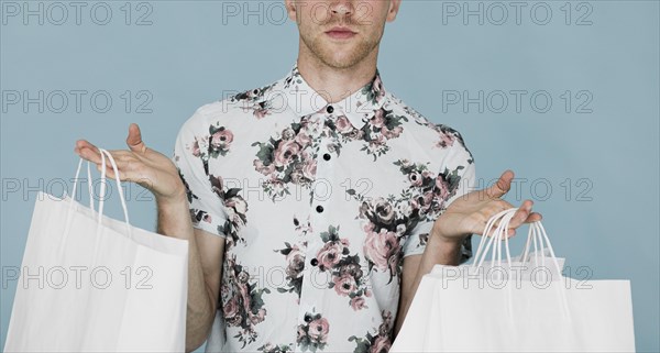 Man shirt holding shopping bags both hands