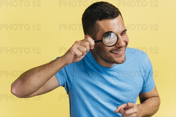 Man watching through magnifier