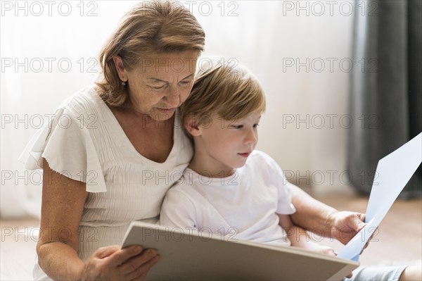 Medium shot grandmother reading book