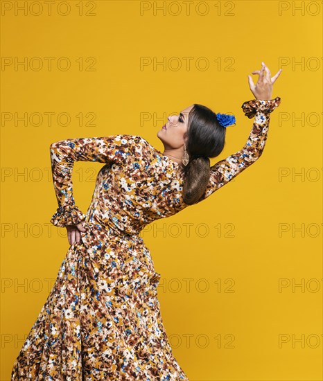 Medium shot woman bending back with orange background