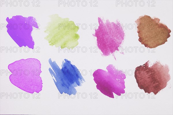 Mix brown green blue violet pink paints white paper
