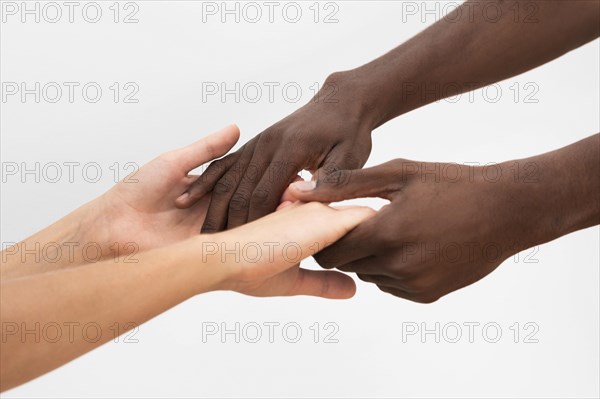 Multiracial hands coming together 3