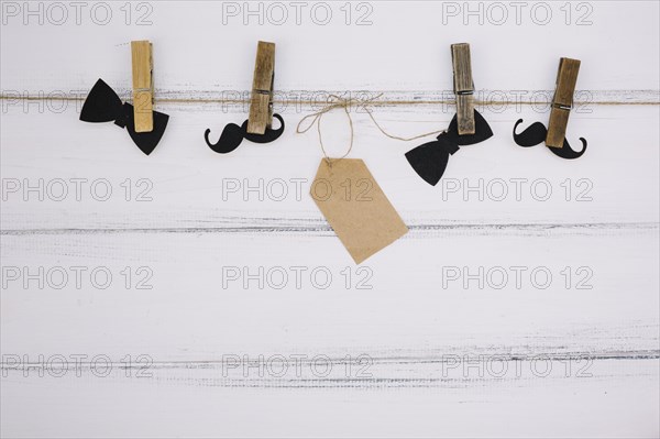 Ornament paper bow tie near mustache tag thread