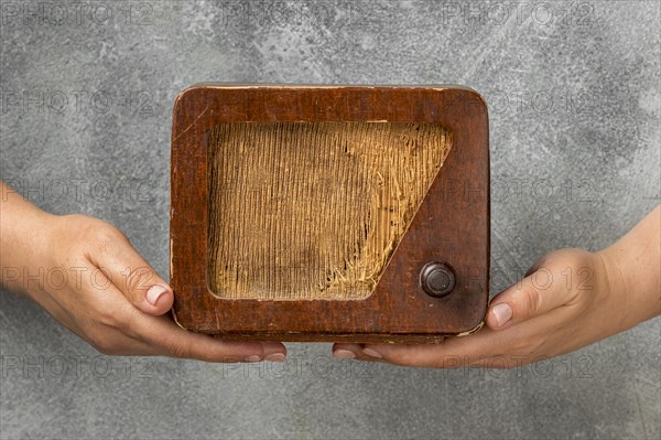 People holding vintage radio