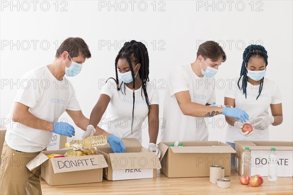 People preparing together donations packages