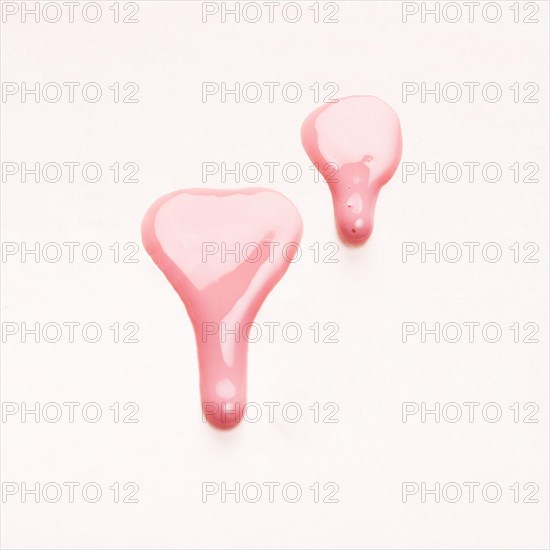 Pink nail polish drops sample isolated white surface