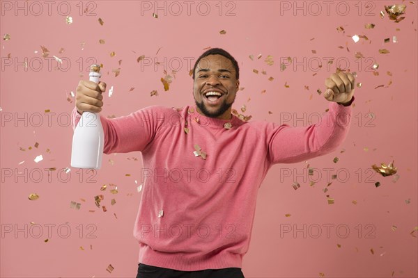 Portrait young man party with champagne bottle