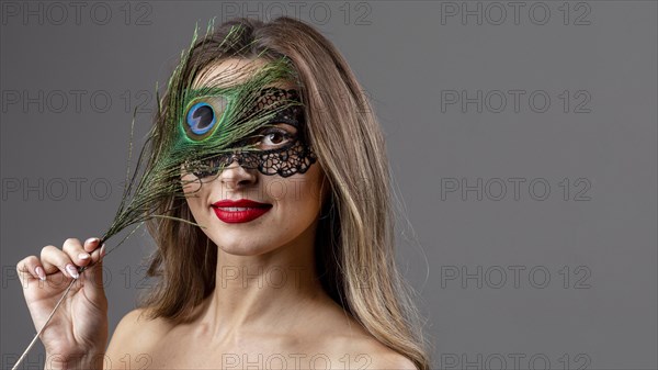 Portrait young woman with peacock feather 3