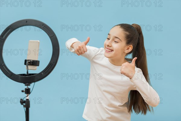 Positive young girl recording video blog