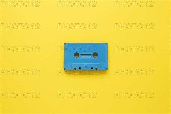 Radio concept with cassette yellow background