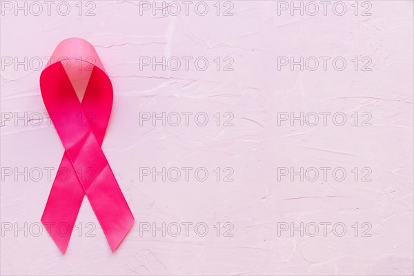 Realistic pink ribbon showing breast cancer awareness symbol pink stone