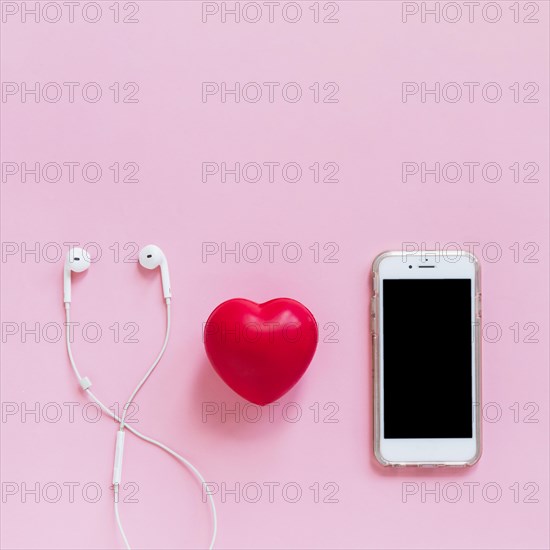 Red heart earphone smartphone pink background