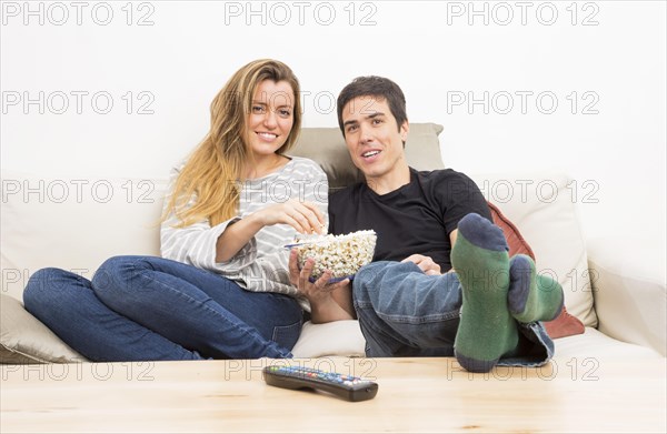 Remote control front couple eating popcorn