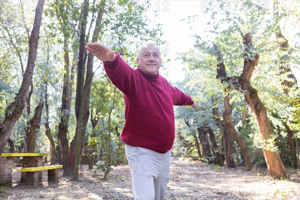 Senior man with sweatshirt exercising