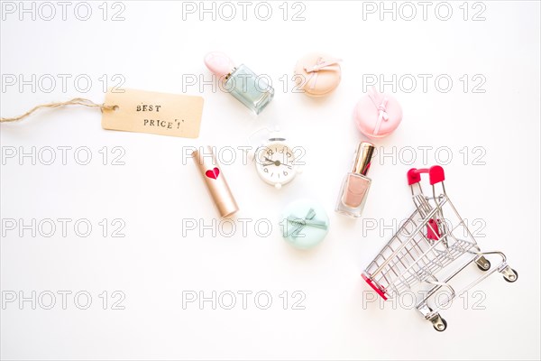 Shopping trolley with little alarm clock macaroons sale tag lipstick nail polish