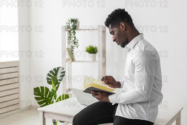 Side view african american man reading