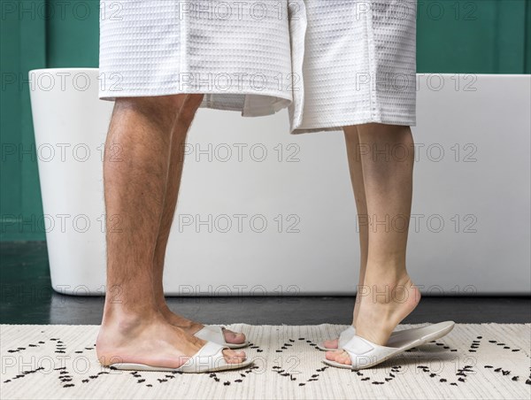 Side view couple bathrobes with slippers