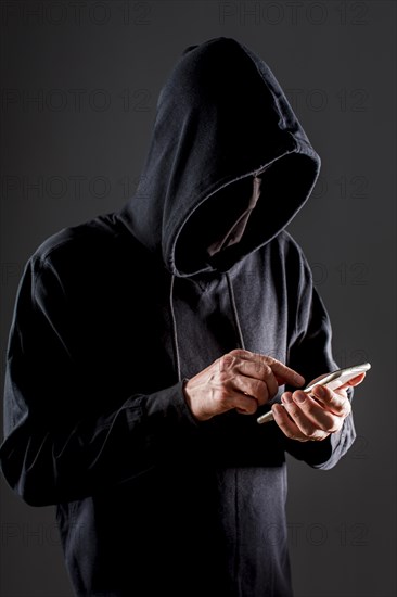 Side view male hacker with smartphone