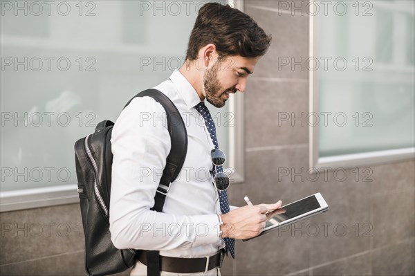 Side view man using digital tablet