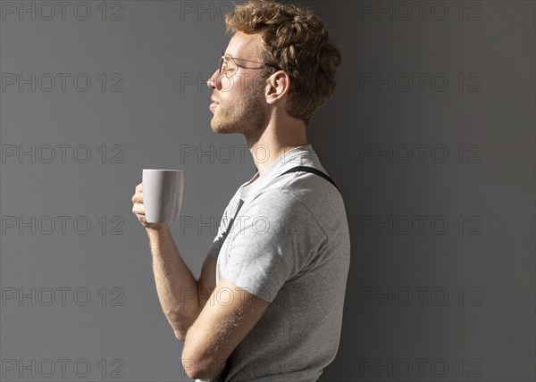 Sideways man drinking his coffee