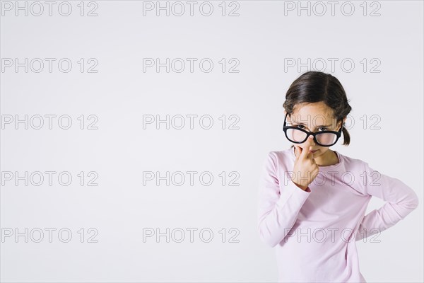 Smart girl adjusting glasses