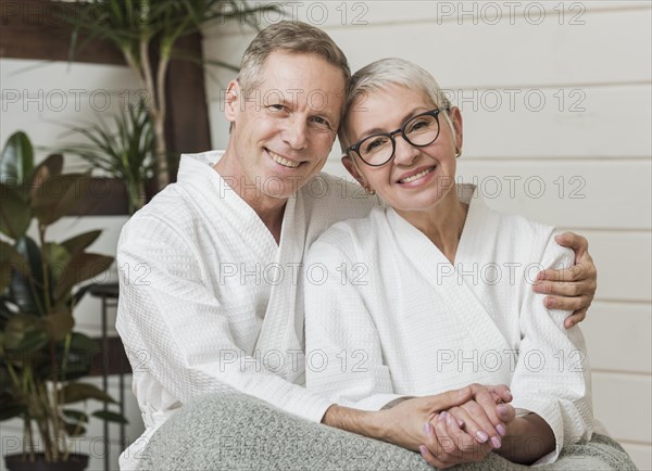 Smiley senior couple holding hands