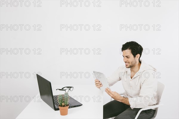 Smiley young man with tablet work