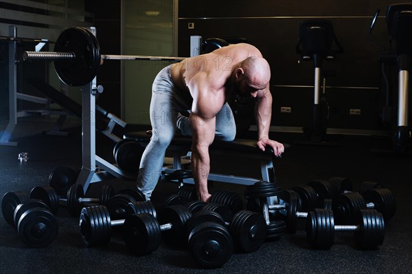 Sportsman preparing lift dumbbell