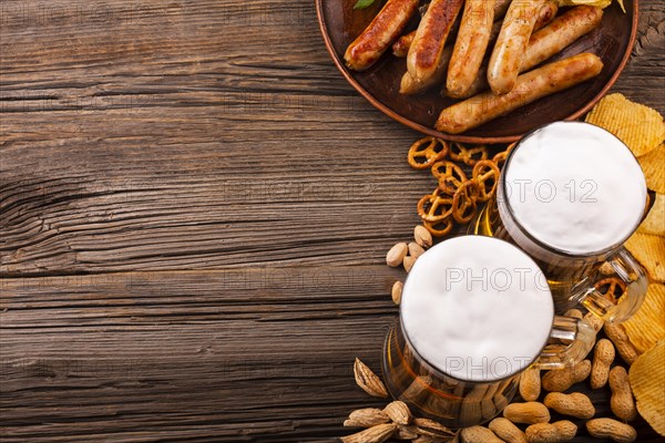 Top view beer with food wooden table