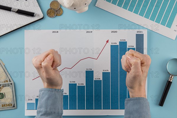 Top view business items with growth chart hands fists