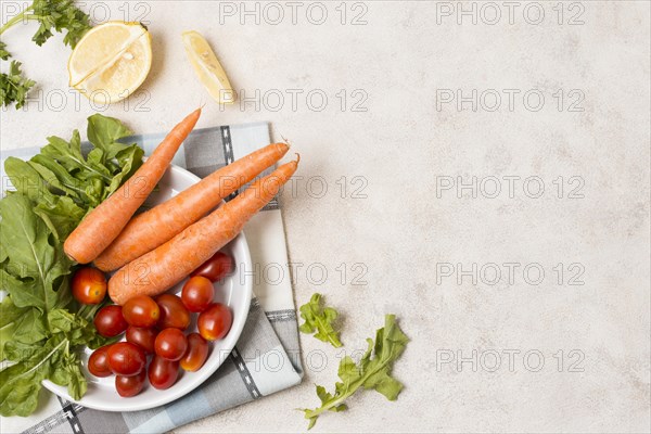 Top view carrots tomatoes plate