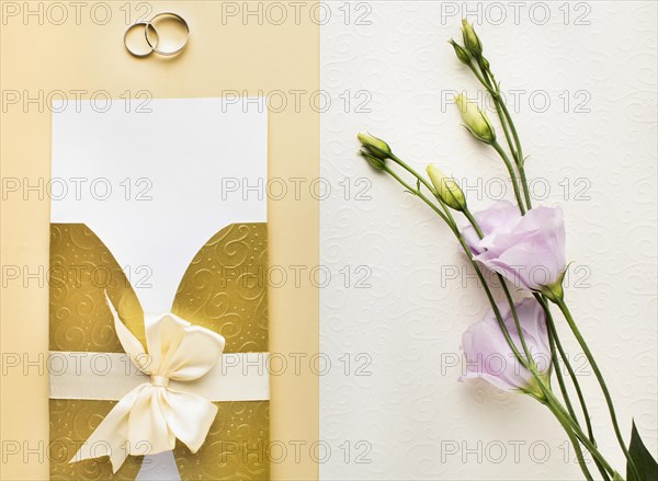 Top view flowers rings luxury wedding stationery