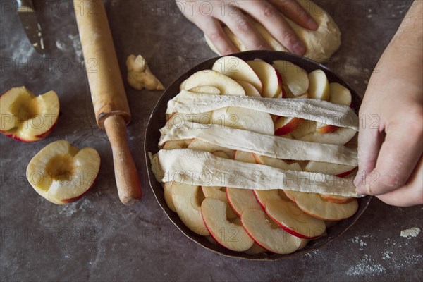 Top view person making apple pie