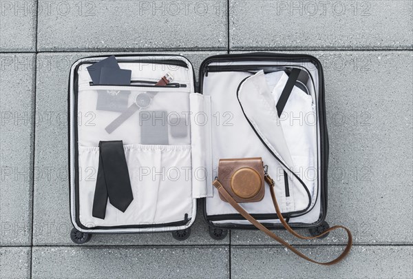 Tourist suitcase sitting ground