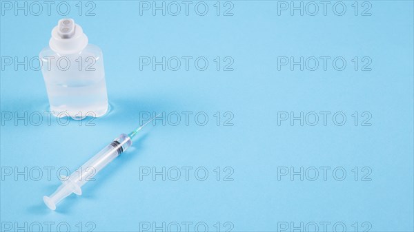 Transparent ampoules syringe blue backdrop