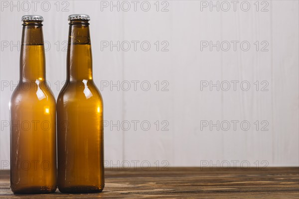 Two beer bottles wooden surface