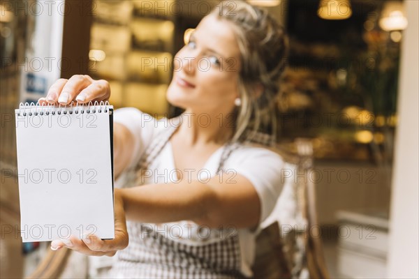 Waitress showing notebook