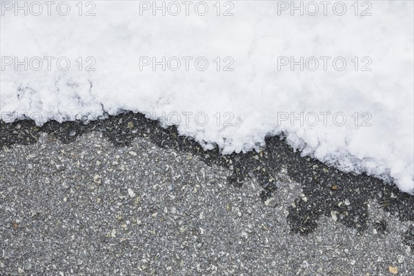 Wet asphalt near snow