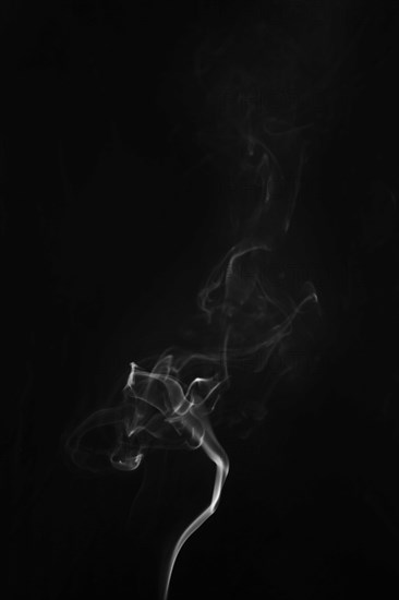 White smoke swirling around black background